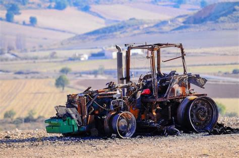 Premium Photo Tractor Destroyed By Fire In The Middle Of The Field
