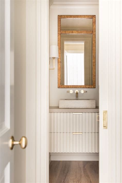 Many people head to their bathroom vanity before starting the day. Simple powder bath with gold accents an fluted, floating ...