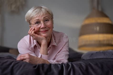 Senior Caucasian Woman Relaxing On Bed Smiling At Camera Stock Image Image Of Calm Mature
