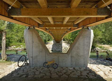 Architects Create Beautiful Arched Footbridge Out Of Timber Planks And
