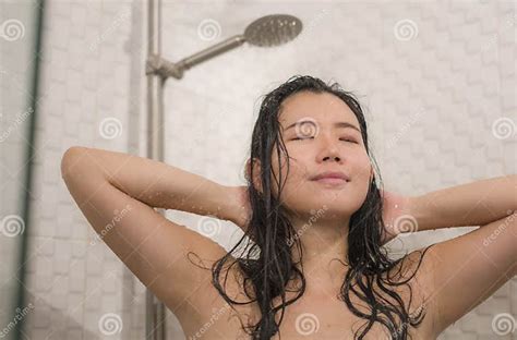 Young Beautiful And Happy Asian Chinese Woman Taking A Shower In The