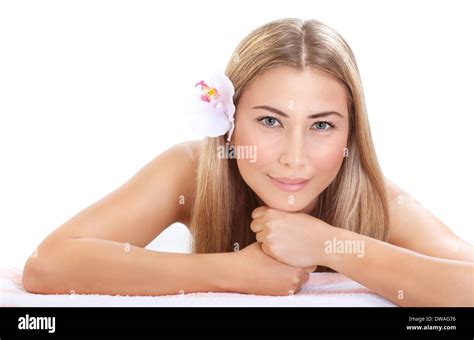 Portrait Of Pretty Woman At Spa Laying Down On Massage Table Isolated On White Background