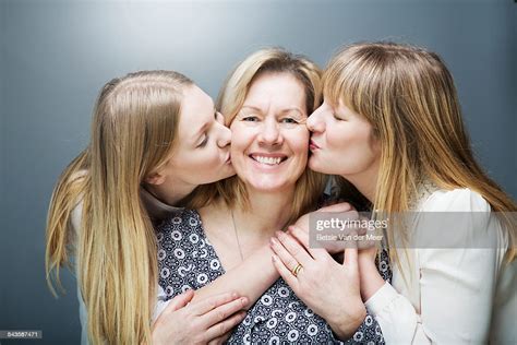 Mother Being Kissed By Daughters On Both Cheeks Photo Getty Images