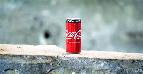 Coca Cola Can On Brown Concrete Surface · Free Stock Photo