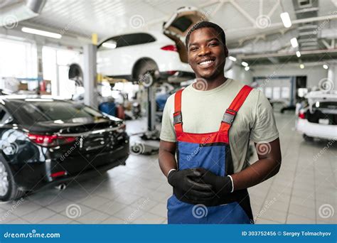 African Man Mechanic In Uniform At The Car Repair Station Portrait
