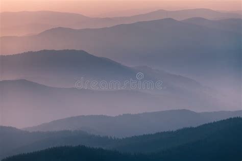 Distant Mountain Range And Thin Layer Of Clouds On The Valleys Stock