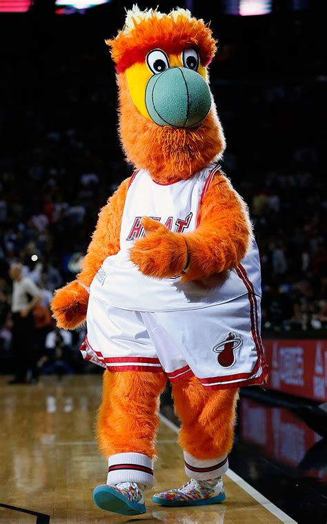 An Orange Mascot Standing On Top Of A Basketball Court