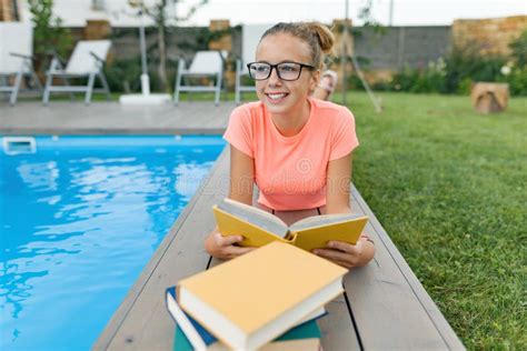 Smart Teenage Girl In Glasses Reading Book Teenager Near House Stock
