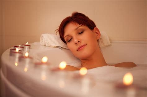 woman lays in bubble bath with candles relaxation exercises relaxing music calming music