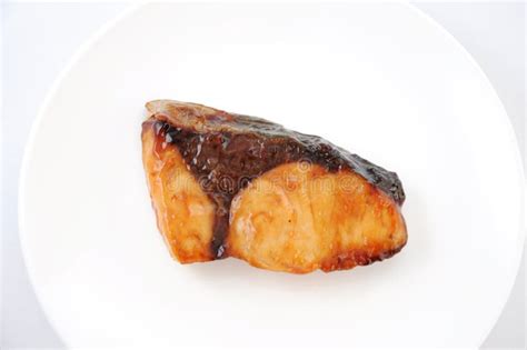 Broiled Teriyaki Fish Japanese Amberjack On Plate On Cutting Board