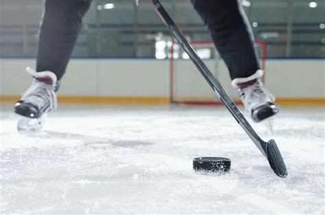 Legs Of Male Hockey Player In Sports Uniform And Skates Moving Down