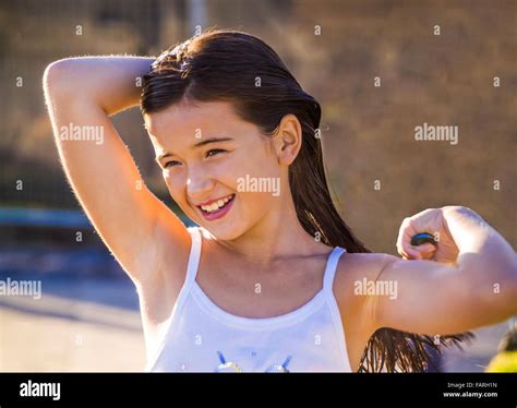Young Girl At The Beach Brushing Her Wet Hair After Swimming St Kilda