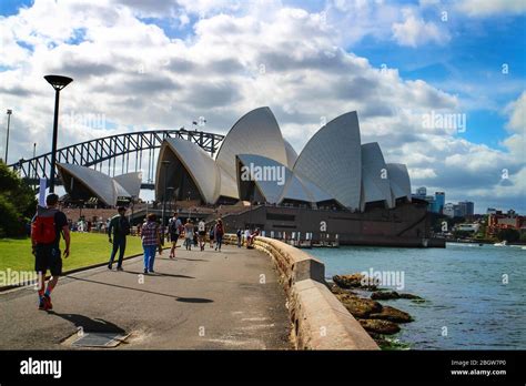 Tourism In Sydney With Visitors Walking Along The Waterfront Of Sydney