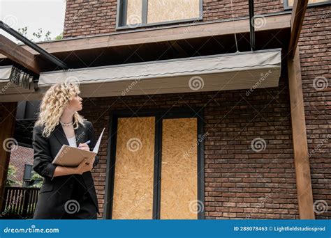 Blonde Real Estate Agent Looking At Stock Image Image Of Business