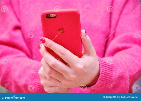 Female Hands Holding The Iphone Apple In A Red Case The Girl Holds The