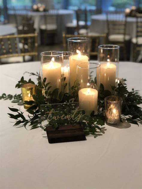 Simple Candle And Greenery Centerpiece In 2021 Candle Wedding Centerpieces Simple Wedding