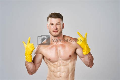Man With A Pumped Up Naked Body In Rubber Gloves Gesture With His Hands