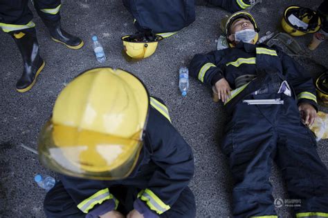 Exhausted Firefighters Napping On The Ground At The Tianjin Blast Site