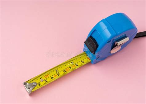 Measuring Tape With Centimeters And Inches On Pink Background Stock