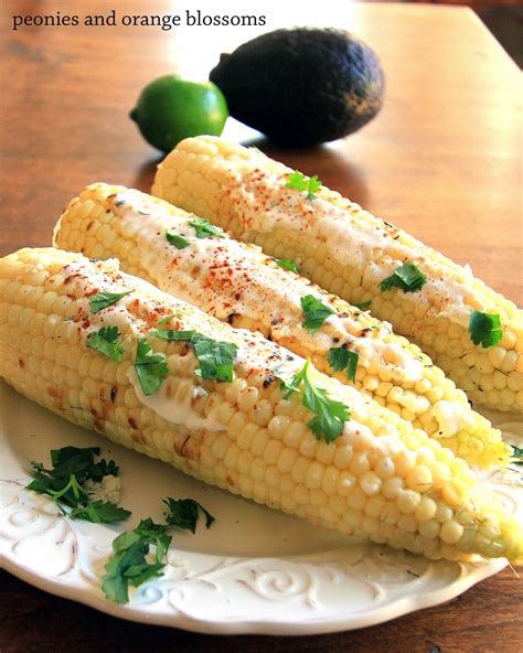 Mexican street corn with chilies, cilantro, and lime. Mexican Street Corn Recipe - Petite Haus