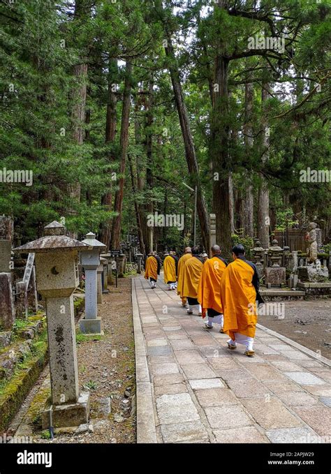 Monks Walking On The 2 Km Long Path With Ancient Tombs In The Okunoin