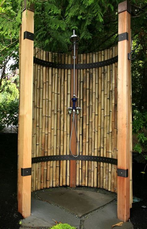 An Outdoor Shower Made Out Of Bamboo Sticks