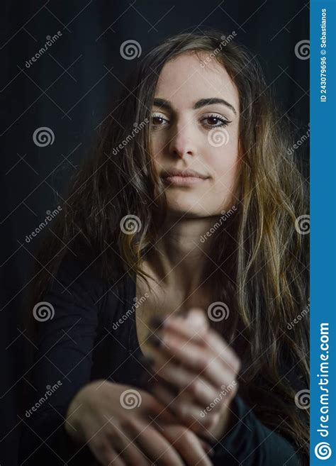 portrait of a beautiful italian girl with long hair gesticulating with a seductive look stock