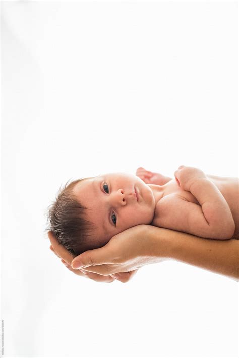 Newborn Baby Held By Mother S Arms Del Colaborador De Stocksy