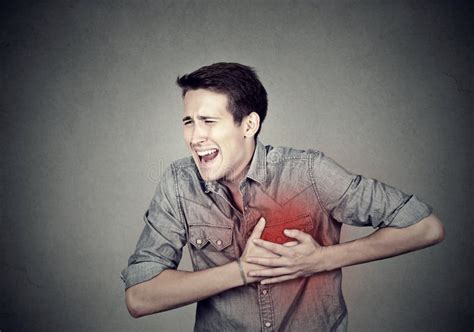 Man Suffering From Severe Sharp Heartache Chest Pain Stock Photo