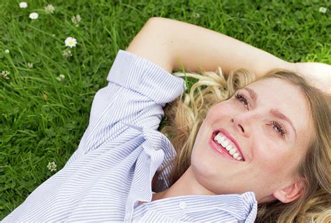 Woman Lying On Grass Smiling Photograph By Ian Hootonscience Photo