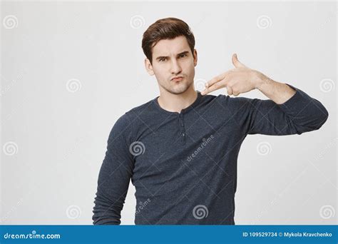 Portrait Of Serious And Confident Handsome Guy With Frowned Eyebrows