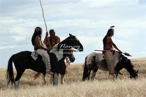 Three Native American Indians On Horseback On The Prairie Of South