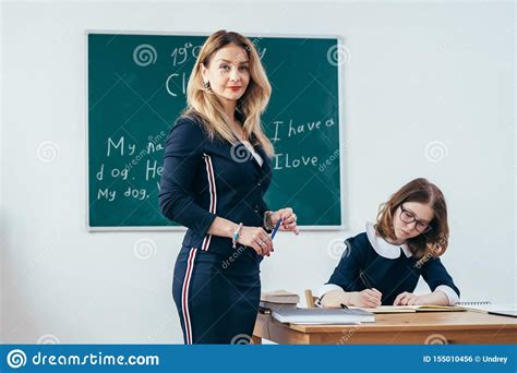 Portrait Of Young Caucasian Female Teacher In School Classroom Stock