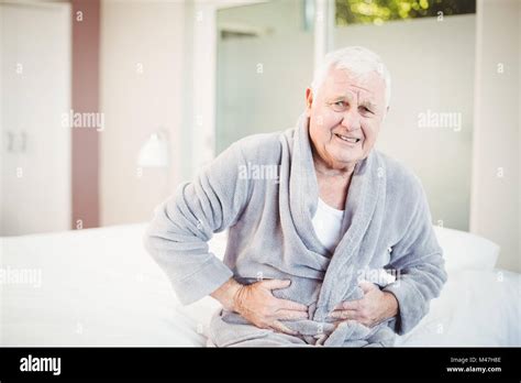 Portrait Of Senior Man Frowning With Stomach Ache Stock Photo Alamy
