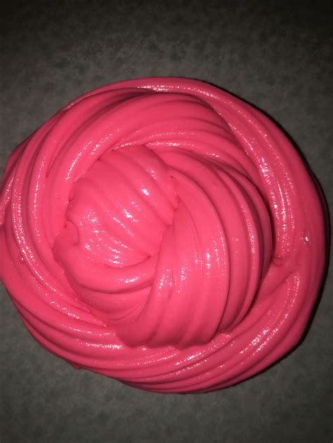 A Pink Substance Is In The Middle Of A Circle On Top Of A Gray Surface