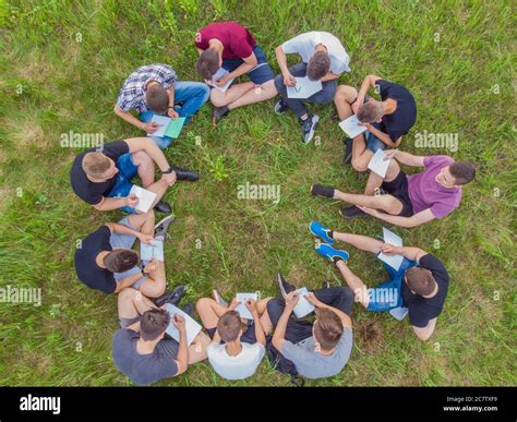 Teamwork Concept A Group Of High School Students Sit On The Grass In A