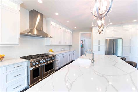Antique white kitchen cabinets with dark wood floors. White Kitchen Countertops Project | Premium Granite