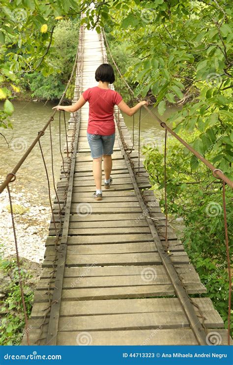 girl walking on a wooden bridge over a river stock image image of girl cheile 44713323