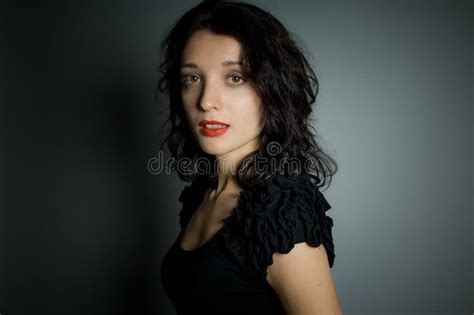 Studio Portrait Of Brunette Woman With Red Sensual Lips Looking At The