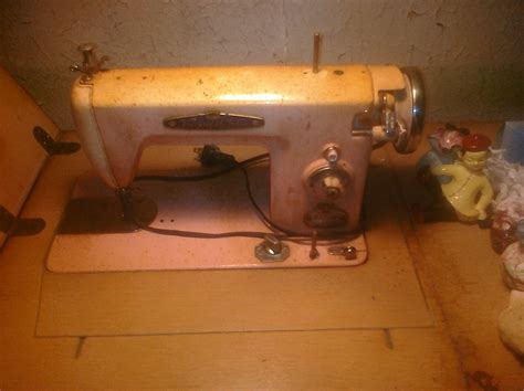 It Says Voguestitches Pink Sewing Machine In Wooden Cabinet