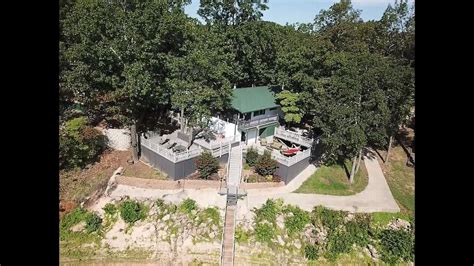 An Aerial View Of A House Surrounded By Trees