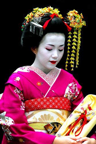 an advanced maiko she ll soon be a fully fledged geisha you can tell by her hair do and collar
