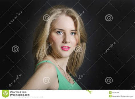 Beautiful Blond Girl With Blue Eyes In The Green Dress Smiling O Stock