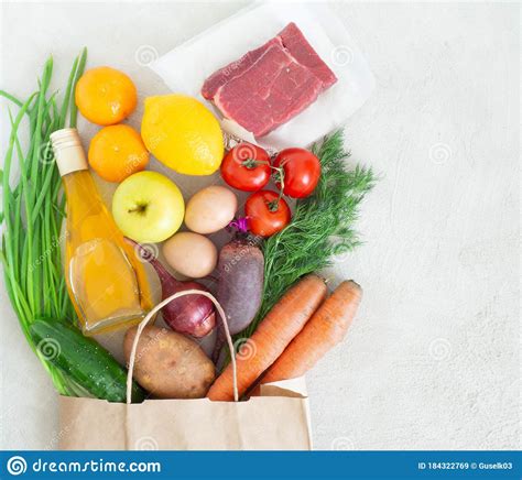 Paper Bag With Various Healthy Food On A Gray Concrete Background