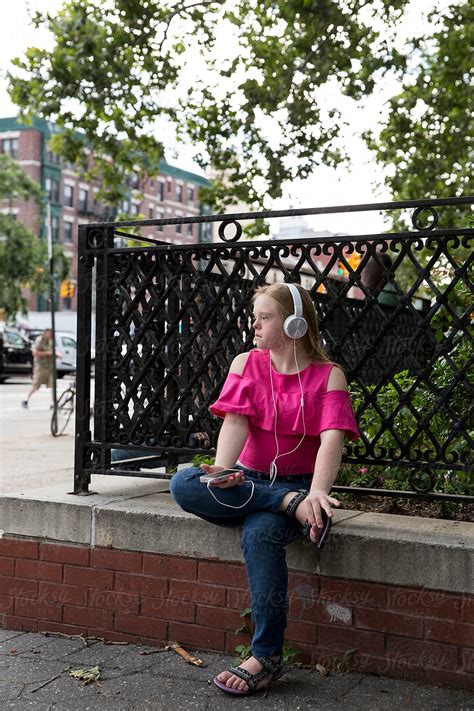 Girl With Down Syndrome Listening To Music By Stocksy Contributor