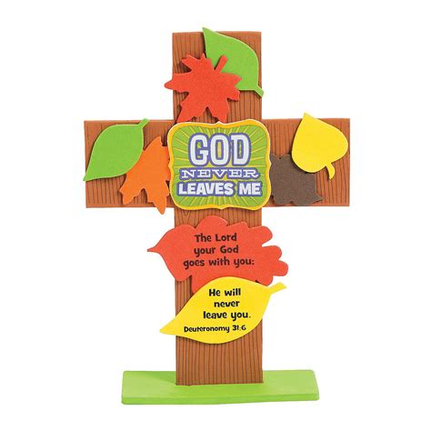 A Wooden Cross With Leaves On It And The Words God Never Leaves Me Above It