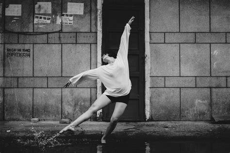 Graceful Dancer Performing On Street Standing In Puddle · Free Stock Photo