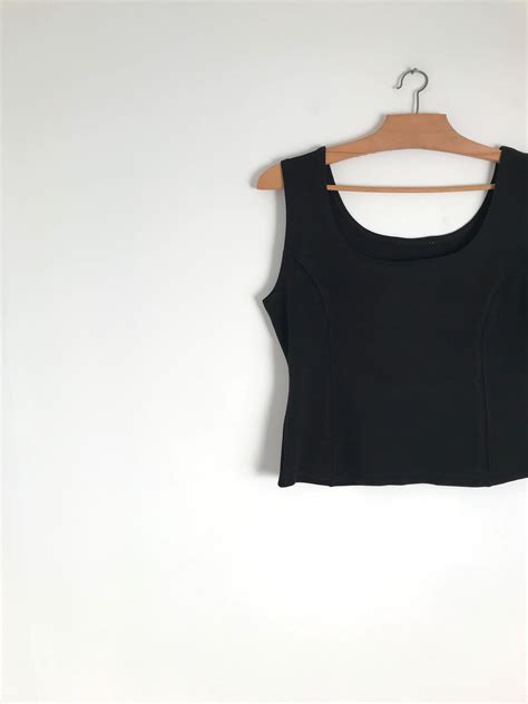 Pixies are the most common and best short haircut for women with round faces. Vintage black crop top / french sleeveless shirt / round ...