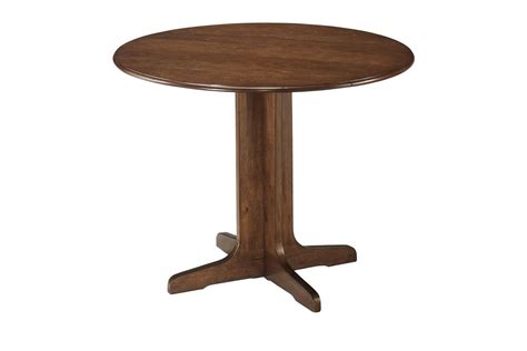 I really like this table, it matched my counters perfectly! Stuman Round Drop Leaf Table by Ashley at Gardner-White