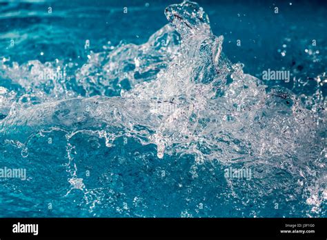Splash Of Water In Swimming Pool With Blue Floor Background Image